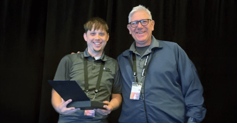 CU Transit employee accepting award for Urban Systems of the Year