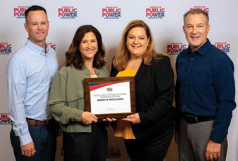 Group of four CU employees accepting an award for 2024 Smart Energy Provider