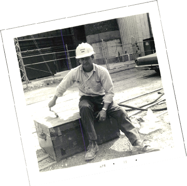 80th Anniversary photo of male CU employee n hart hat at construction site