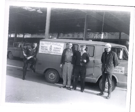80th Anniversary photo of four male CU employees in front of a vehicle